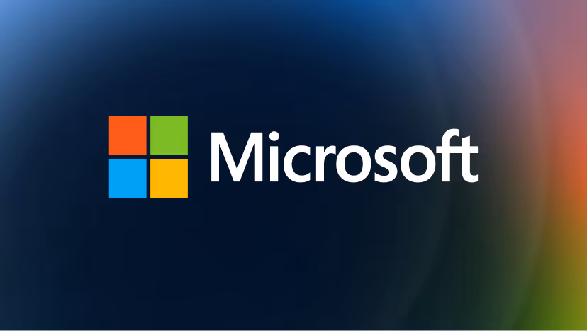 Microsoft logo with four colored squares and the word Microsoft on a dark gradient background.
