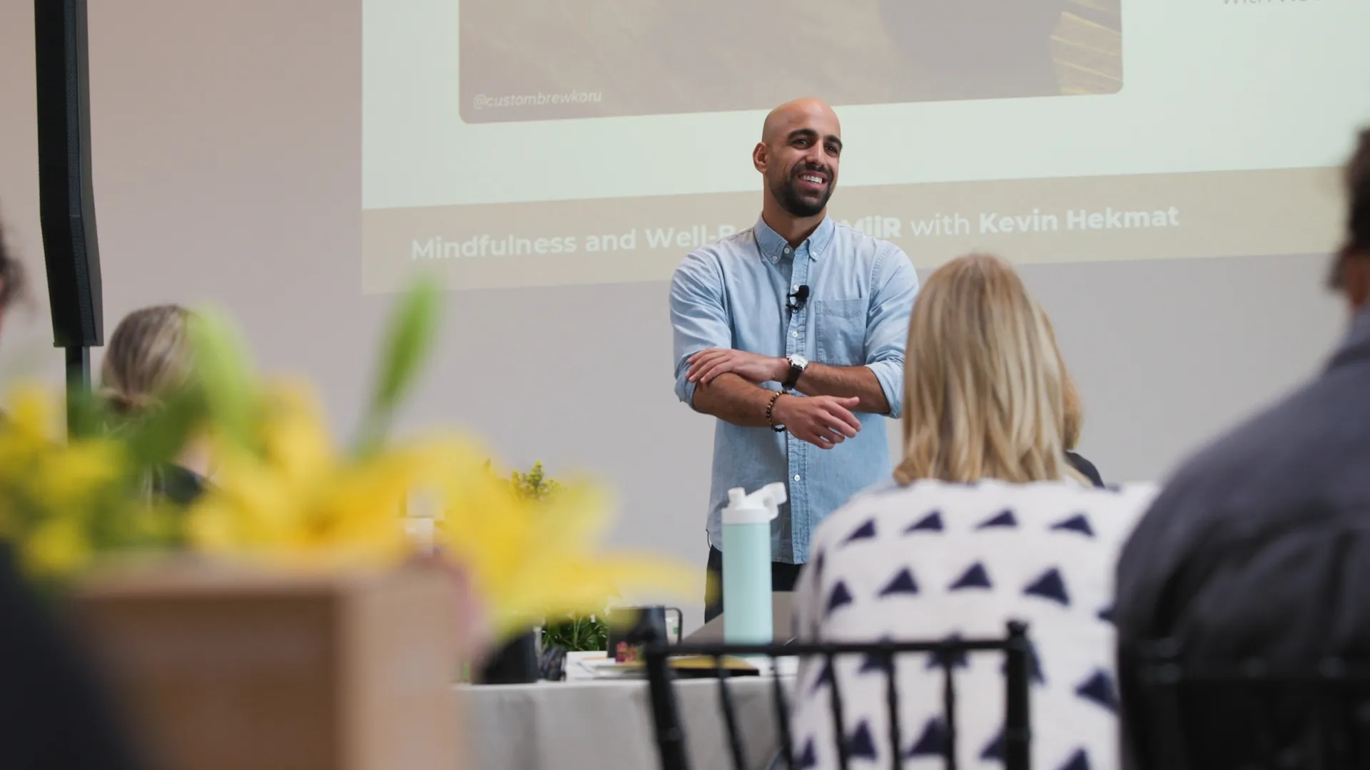 A keynote speaker presenting to an engaged audience during a corporate event, demonstrating how live event video enhances communication and attendee experience