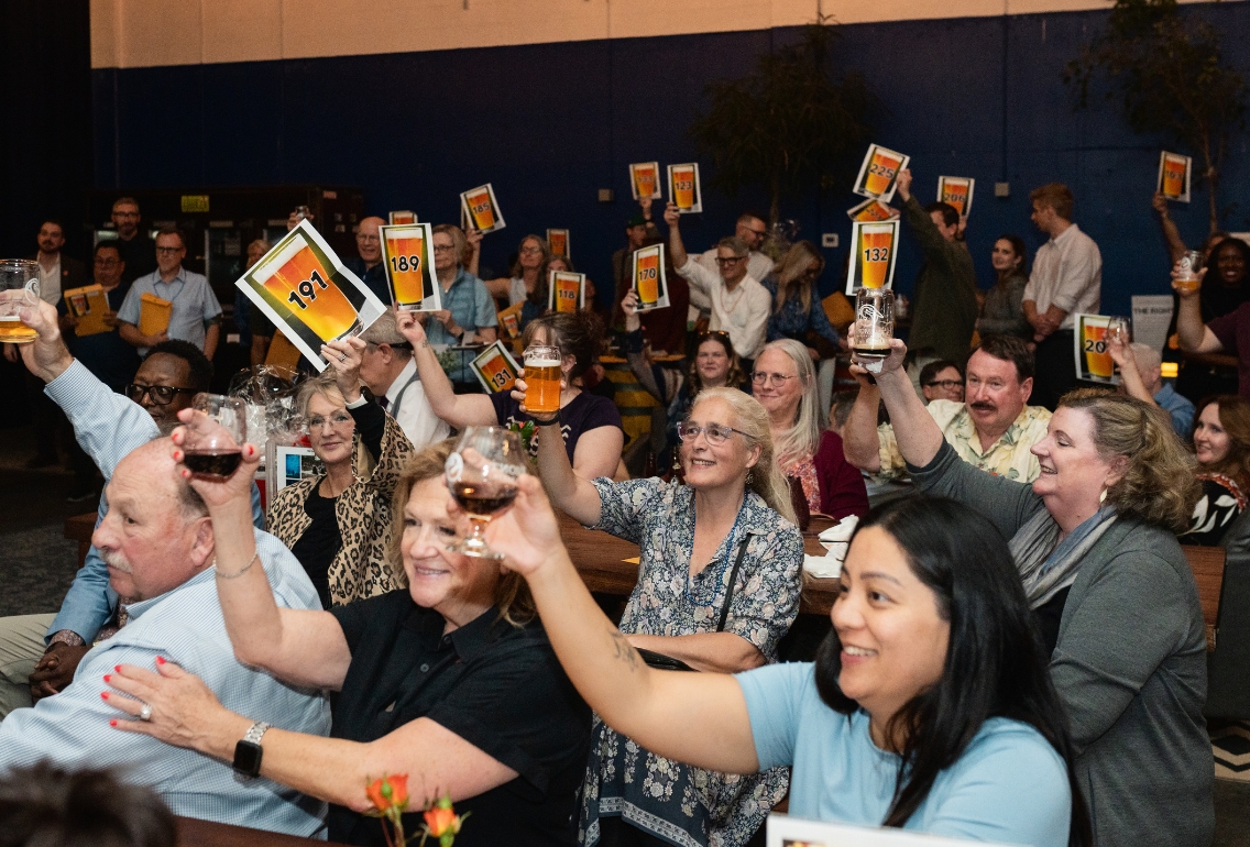 People holding up paddles at an event for Easterseals Washington Fall Fest