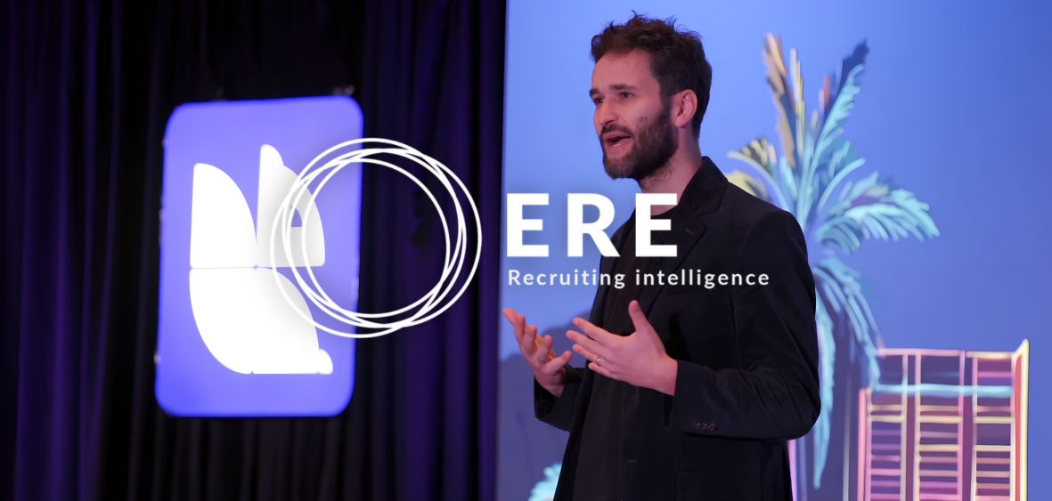 Man on stage during ERE RIS conference