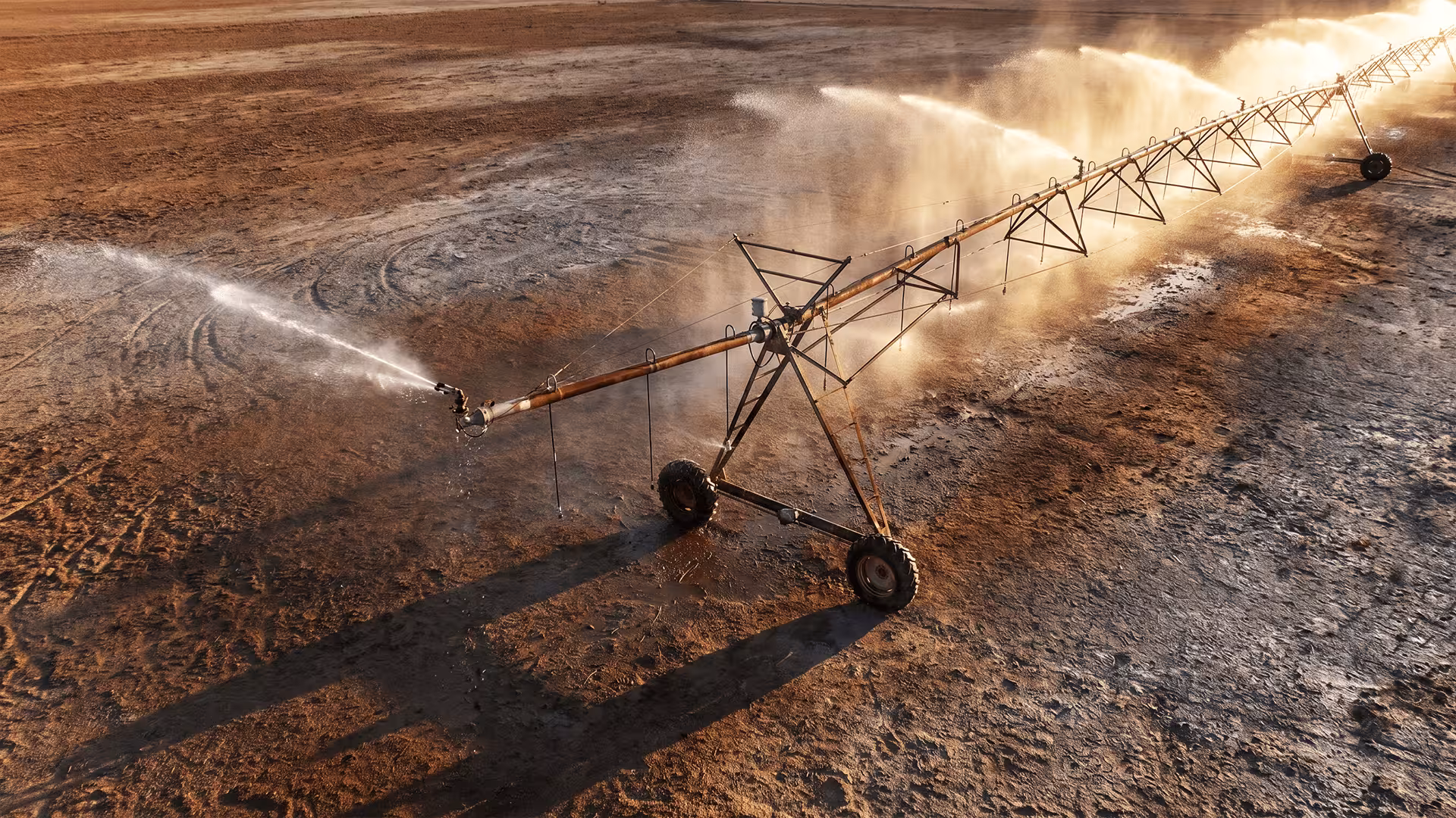 Center-pivot irrigation spraying water onto arid, cracked earth, illustrating B2B marketing infrastructure starved while sales execution is funded