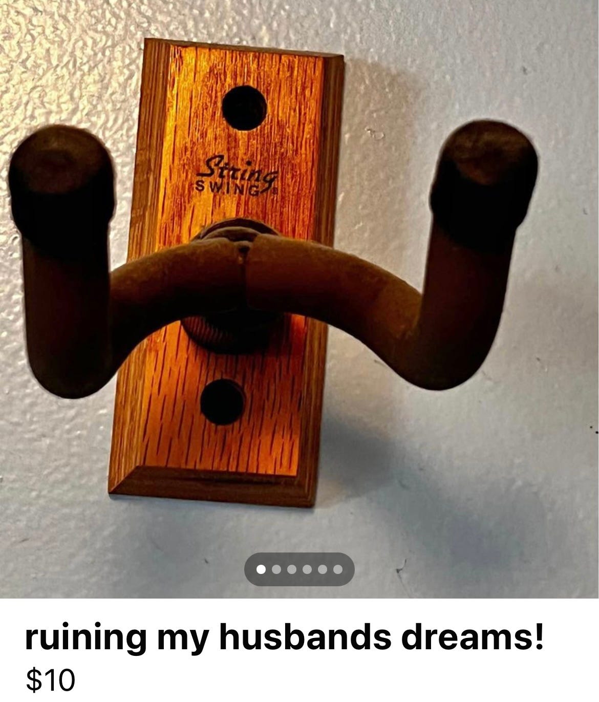 a guitar wall-mount with the listing title, "ruining my husbands dreams!"