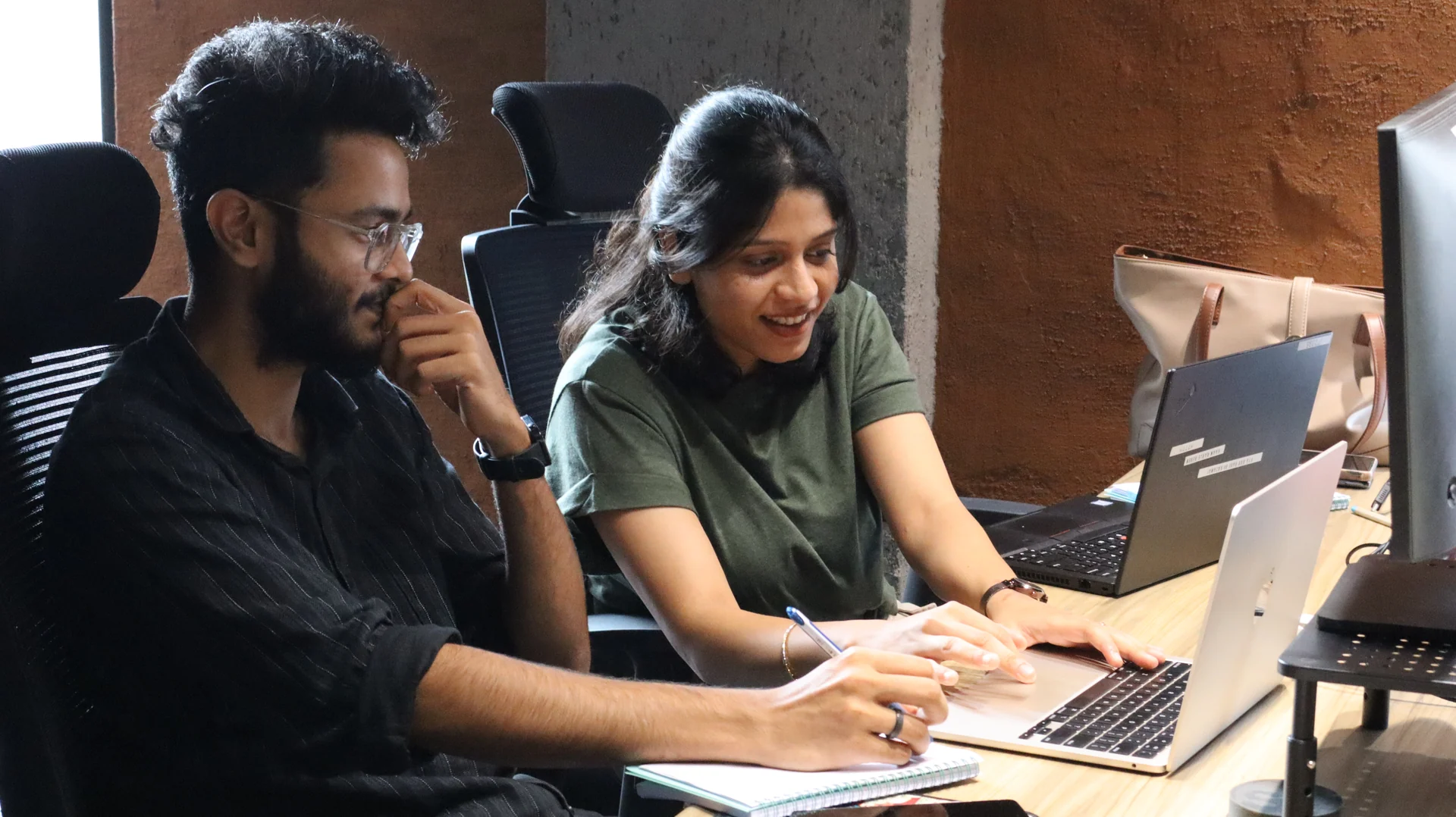 Teammates collaborating on a laptop
