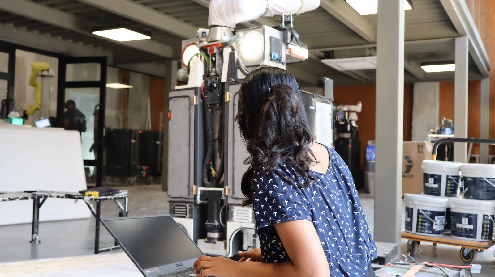 An Origin engineer testing the robot with a laptop