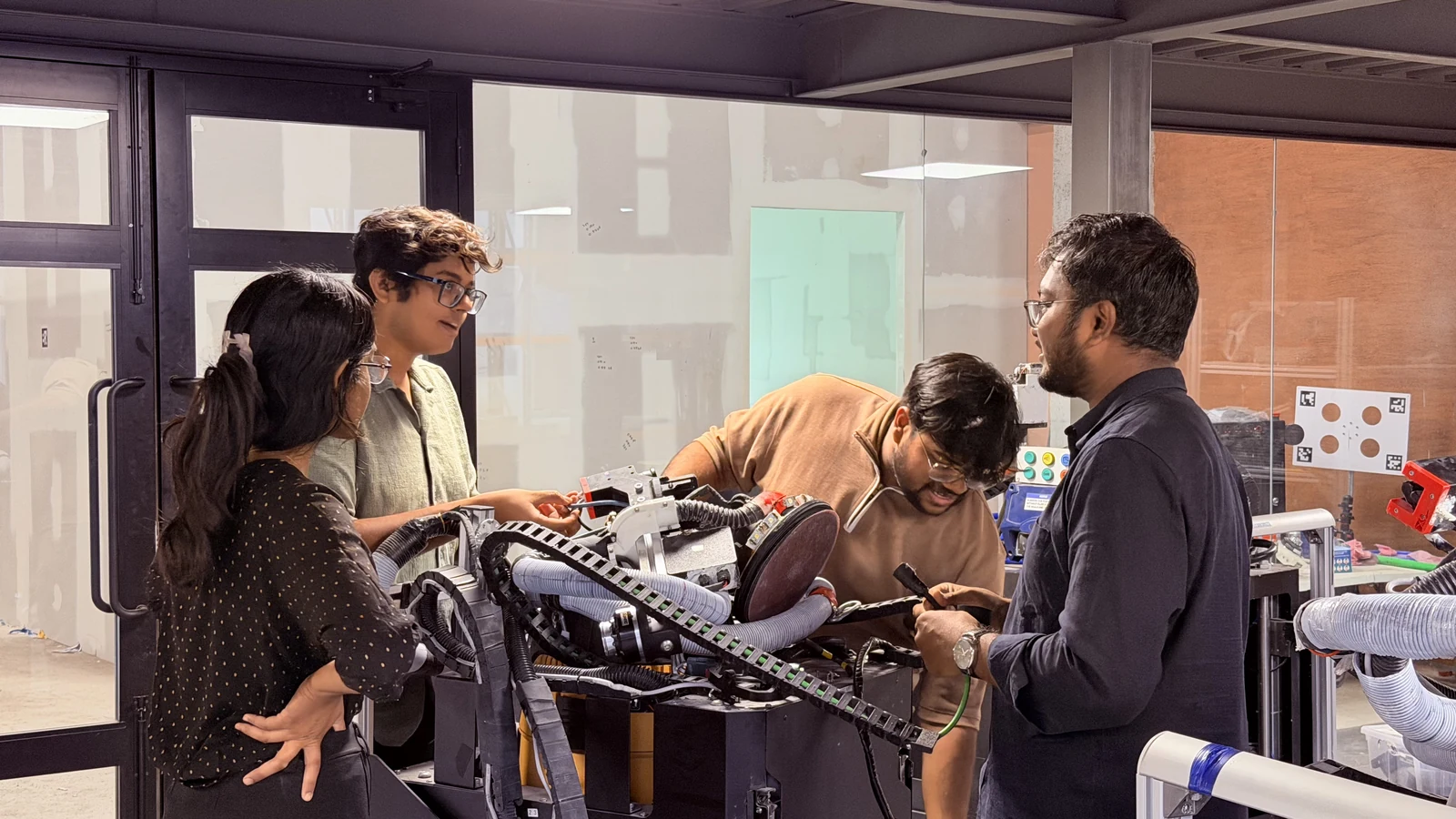 The Origin team assembling and checking robot hardware
