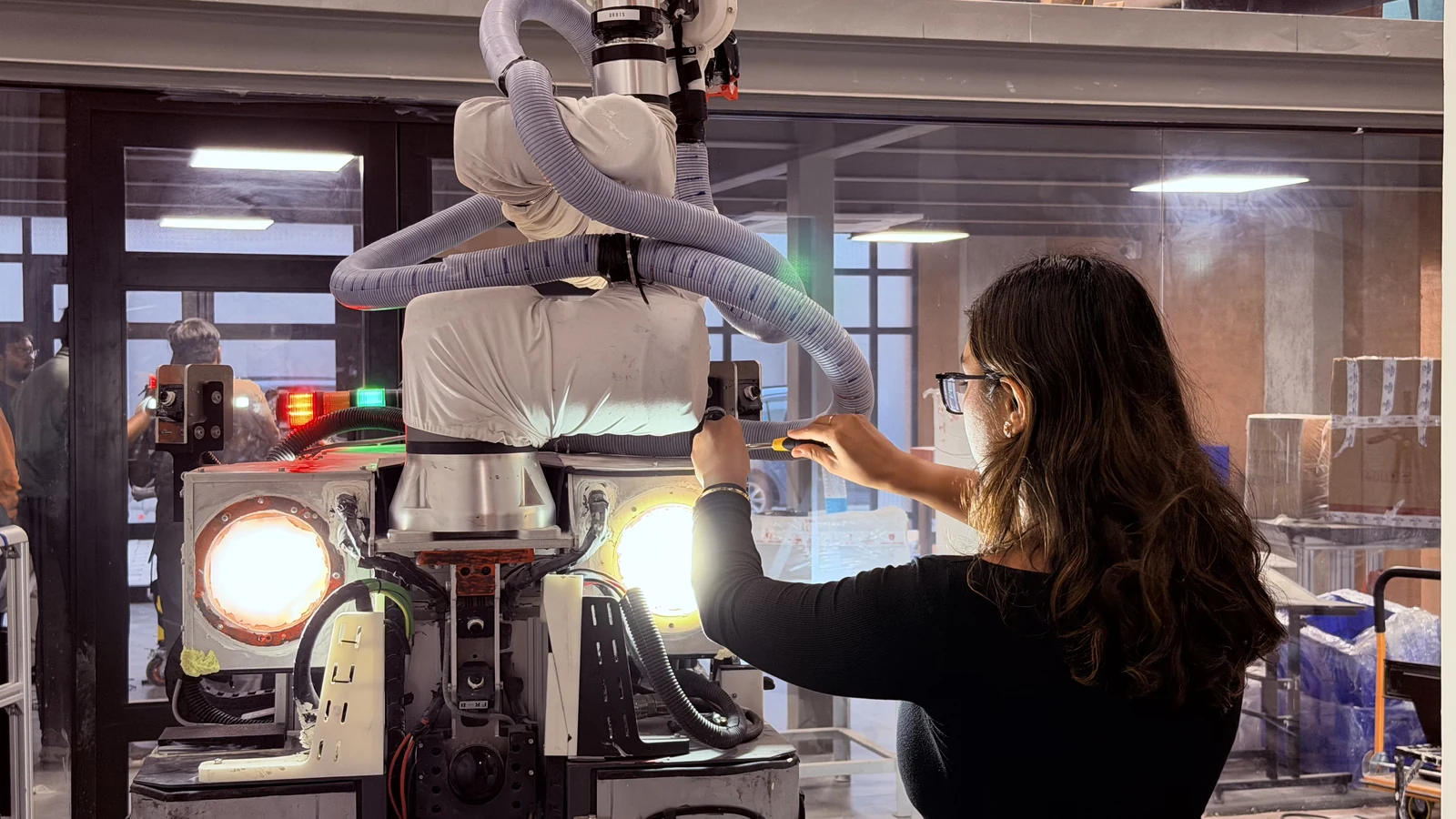 An Origin engineer working on the robot hardware