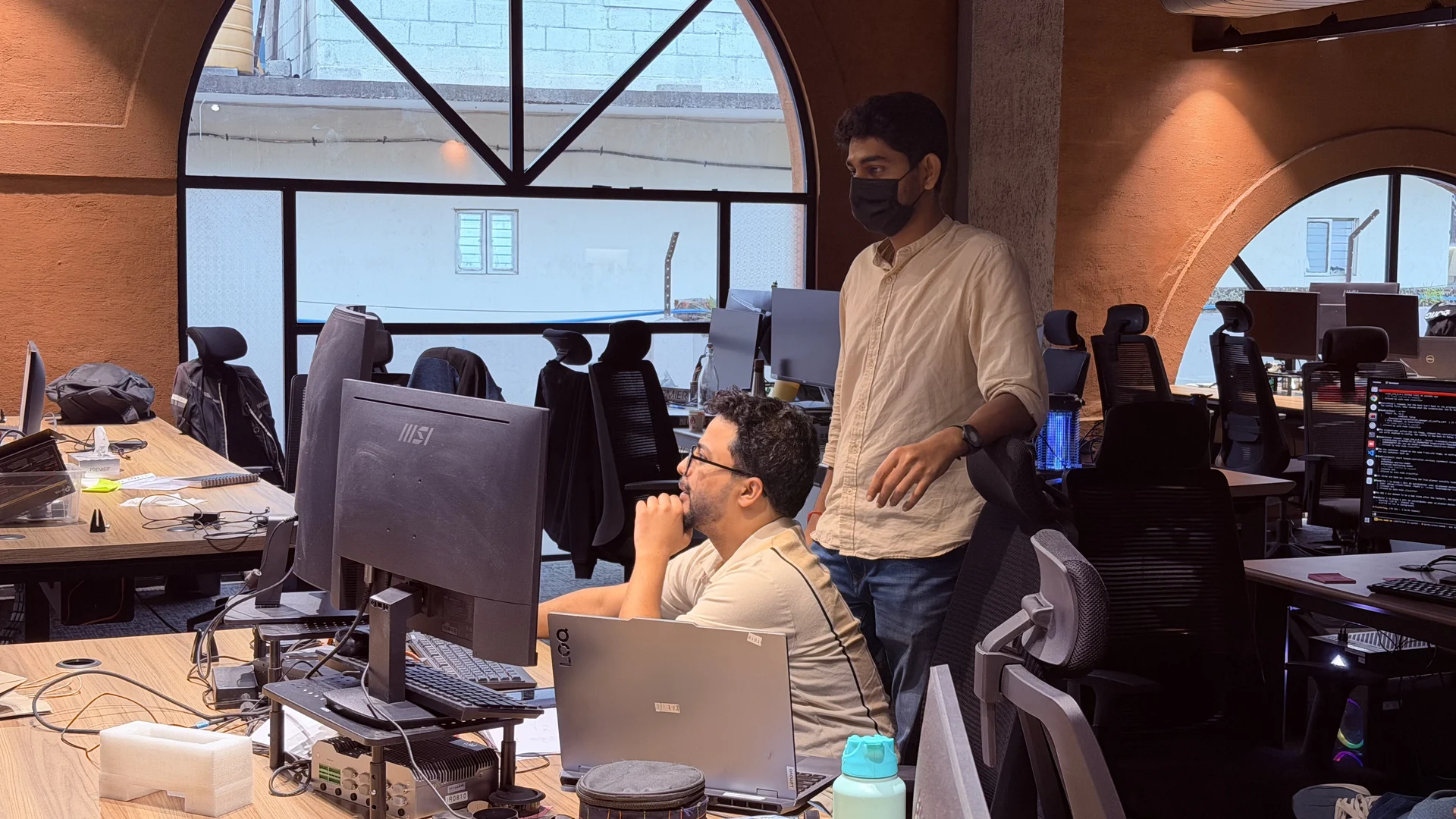Teammates discussing work at the office