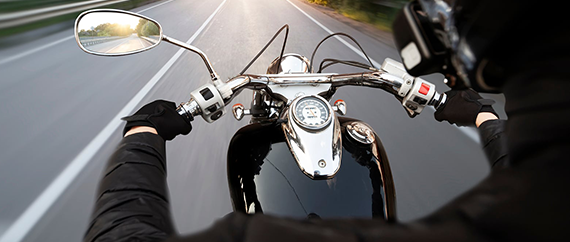 View from a rider's perspective on a motorcycle cruising down an open highway.