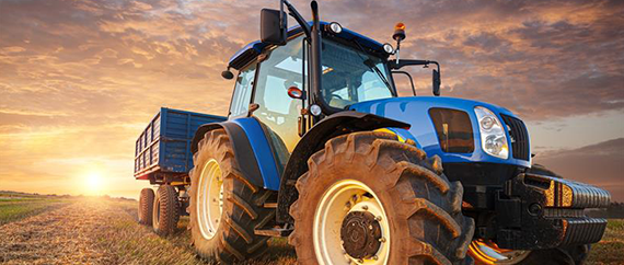 Light gray leather recliner chair with extended footrest in modern living room by a window with curtains.