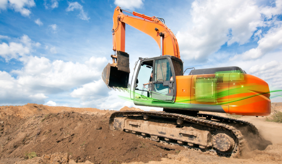 Smiling woman driving a car, viewed from the side through the window.