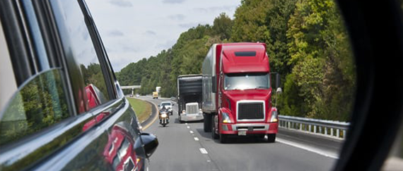 Close-up of a black microchip mounted on a green printed circuit board with visible electronic pathways.
