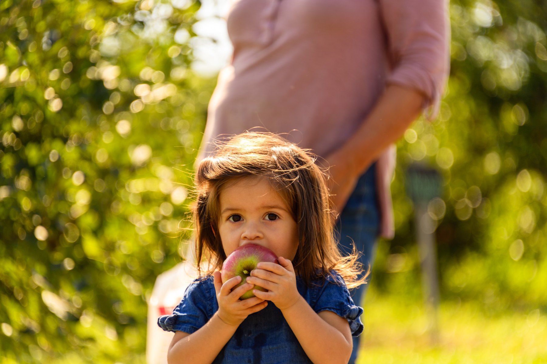 Girl eating a Bishop's Pick Your Own Apple