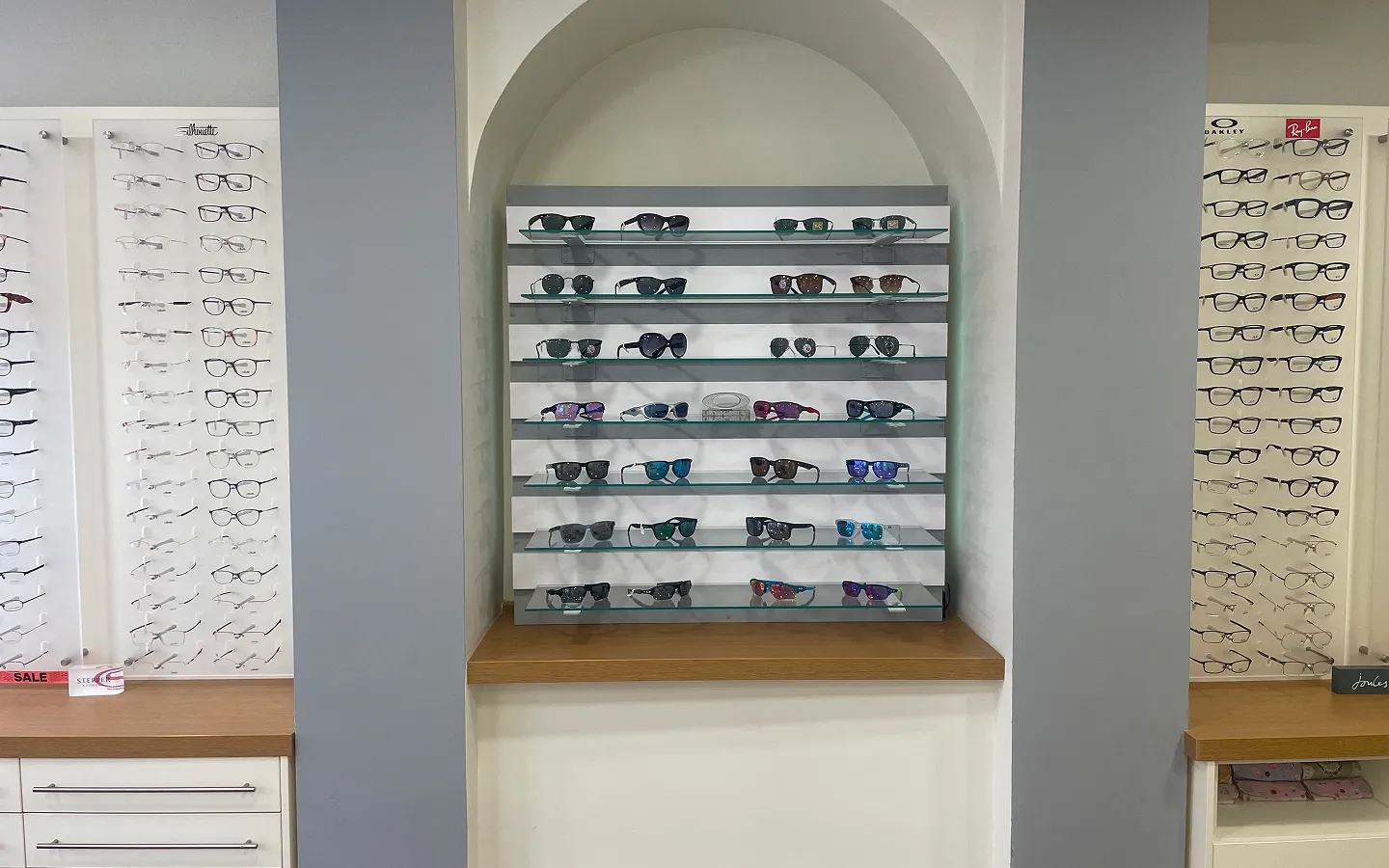 Eyewear showroom displaying extensive collection of designer sunglasses and prescription frames