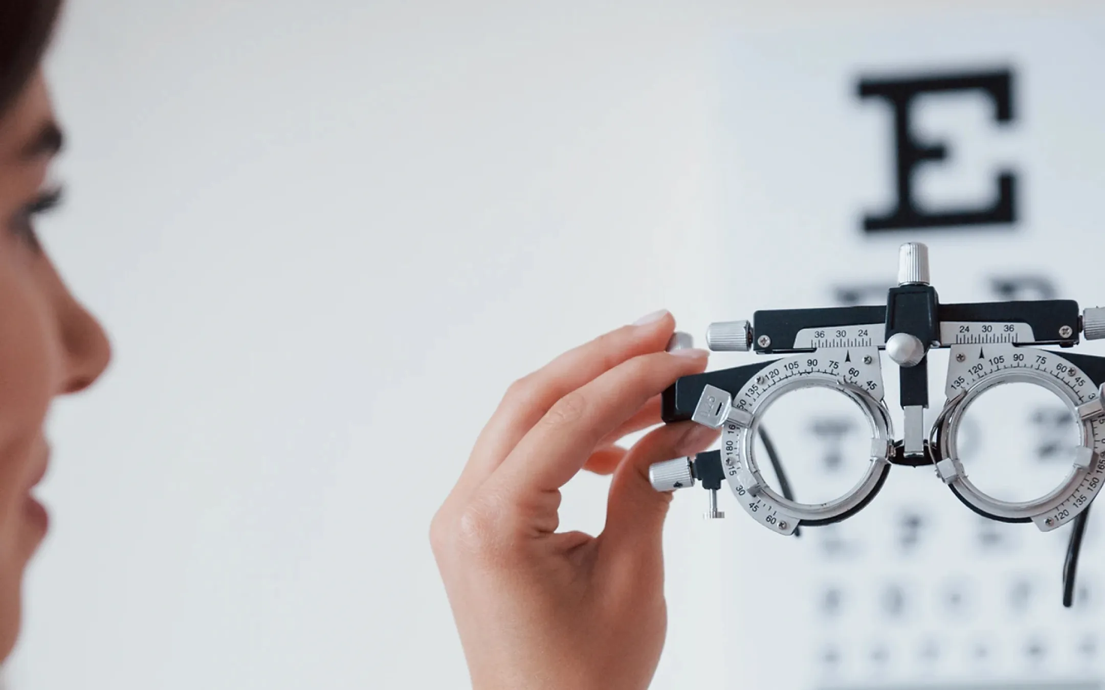 Professional eye examination using phoropter to determine accurate prescription at Clare Derbshyire opticians