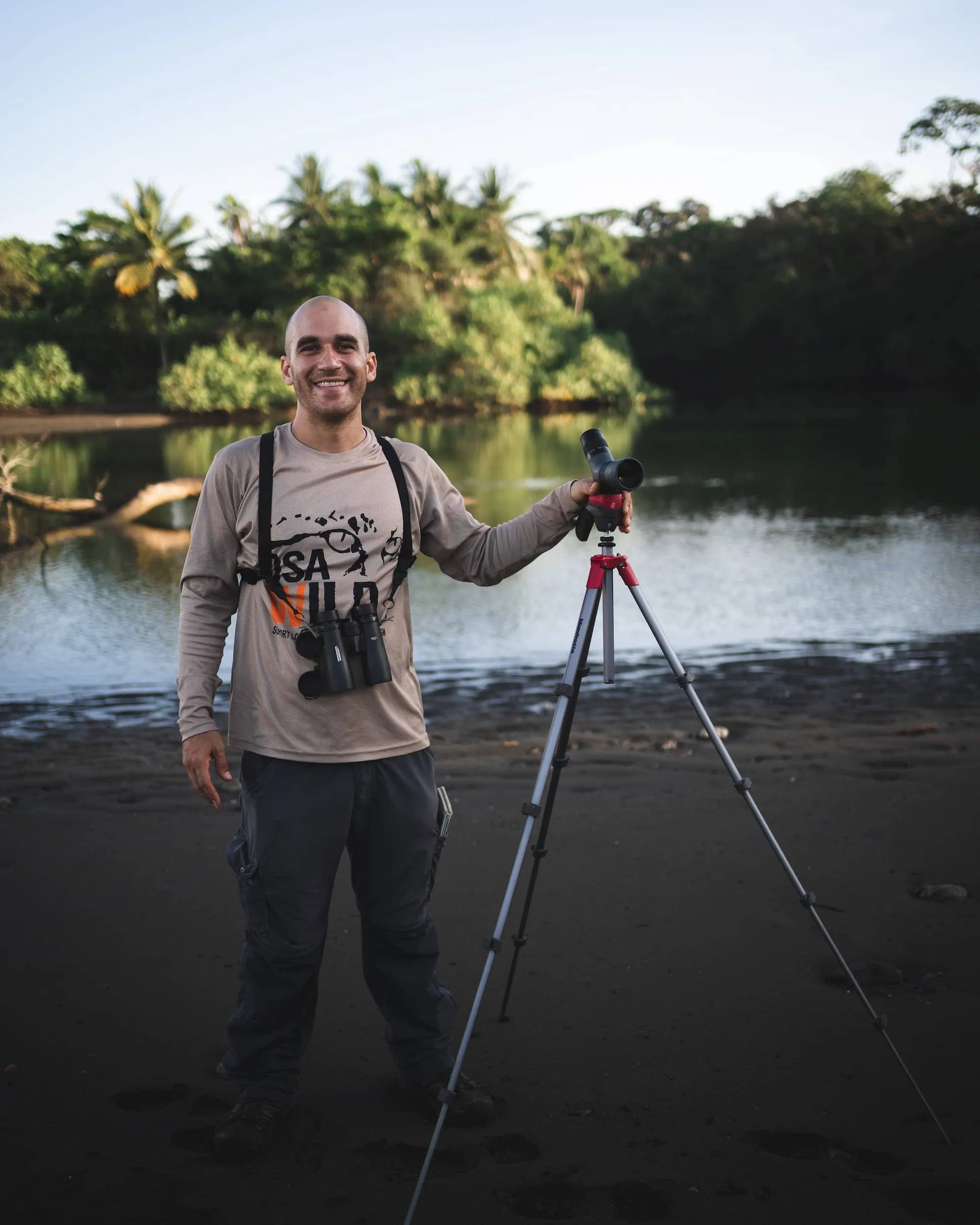 Photographer standing in front of a lush tropical landscape