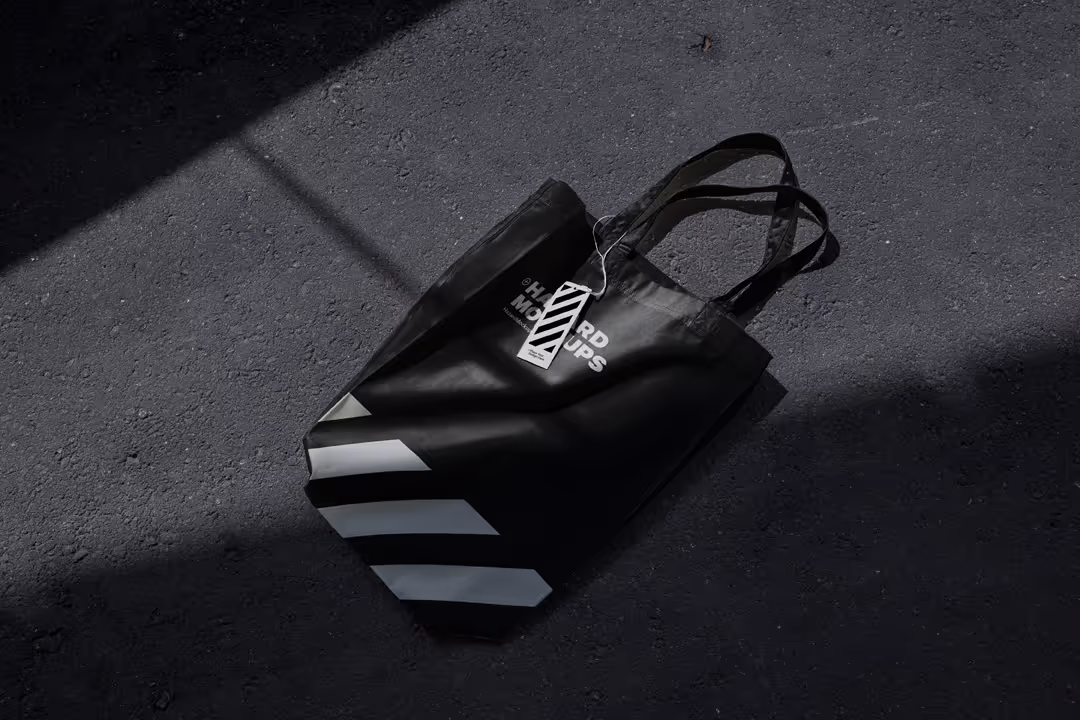 Minimal totebag mockup on dark concrete floor. With realistic shadows and 3D wrapping