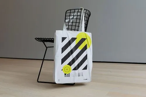 Tote bag mockup hanging on modern chair