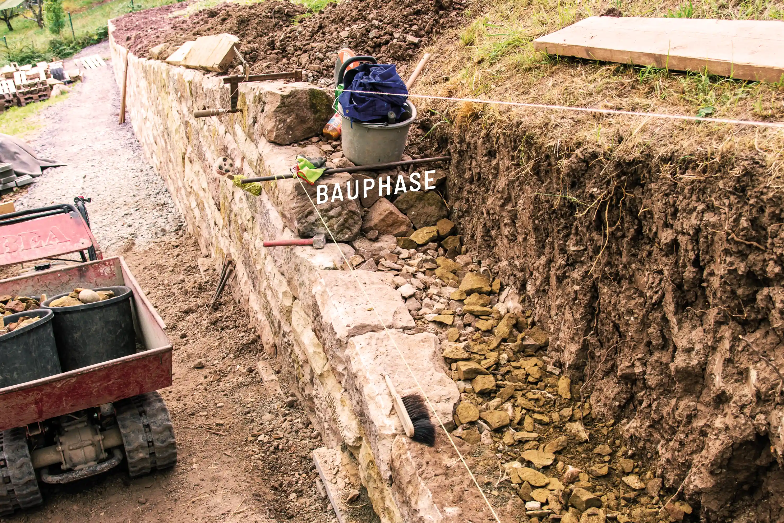 Sanierung der Trockenmauern im Weinberg Auenwald-Lippoldsweiler während der Bauphase mit freigelegtem Hang