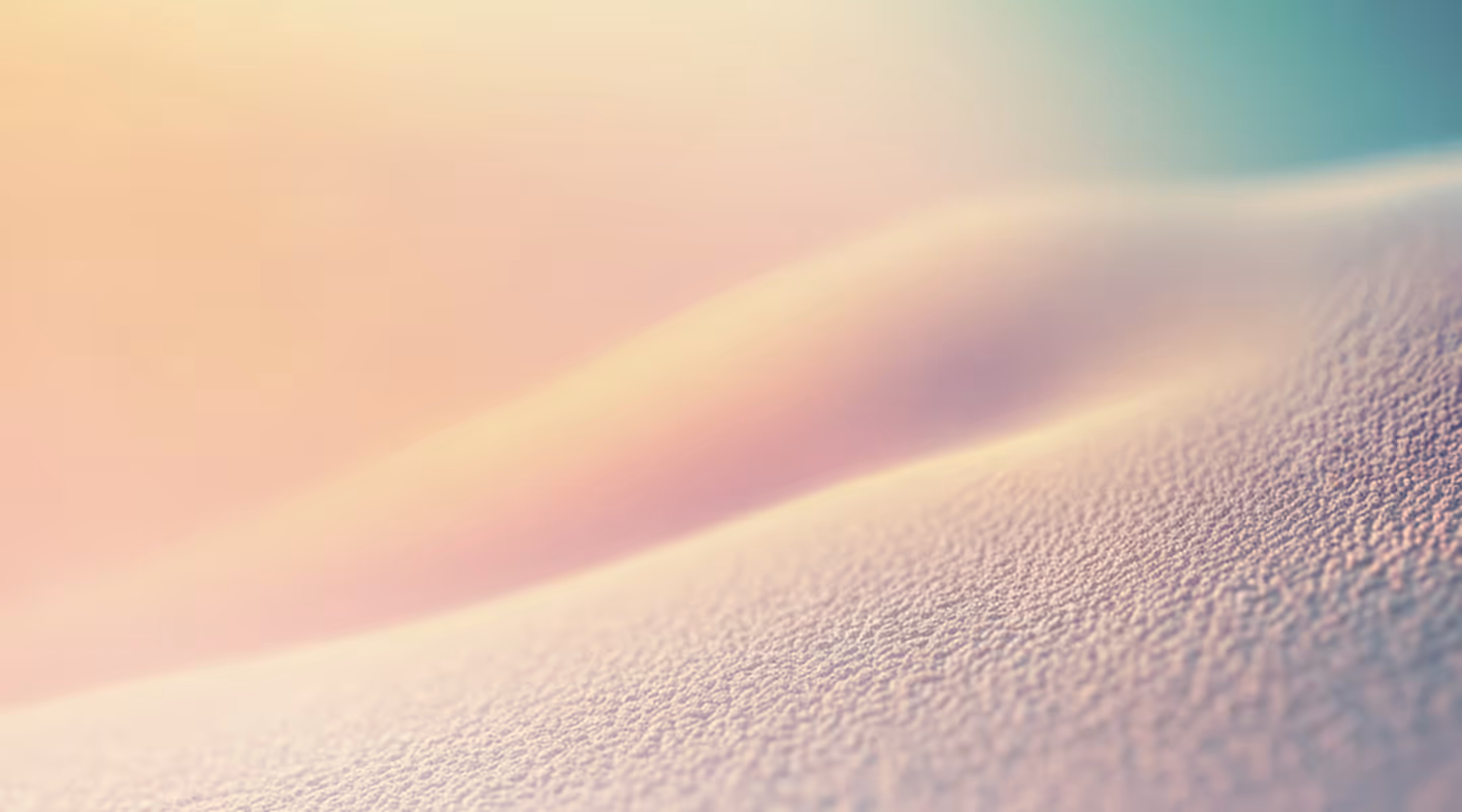 Close-up of textured, soft skin with smooth curves and warm pastel lighting.