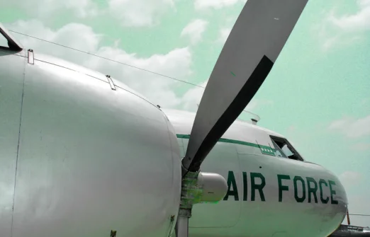 Close-up of an aircraft propeller and nose section with words Air Force on the fuselage.