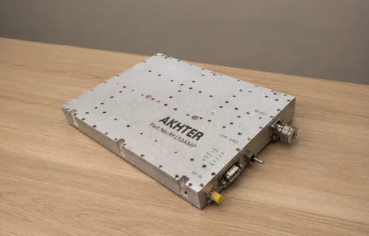 Akhter high-power amplifier device with connectors on a wooden surface.