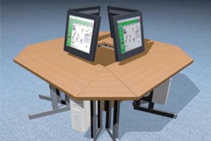 Hexagonal wooden computer desk setup with four monitors and CPUs placed underneath each section.
