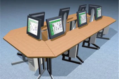 Wooden narrow conference table with six angled monitors displaying control interfaces.