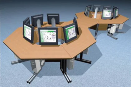 Two linked octagon-shaped desks each with multiple computer monitors facing outward.
