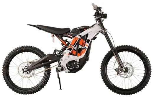 Side view of a black and white Sur-Ron electric dirt bike with knobby tires and orange accents.