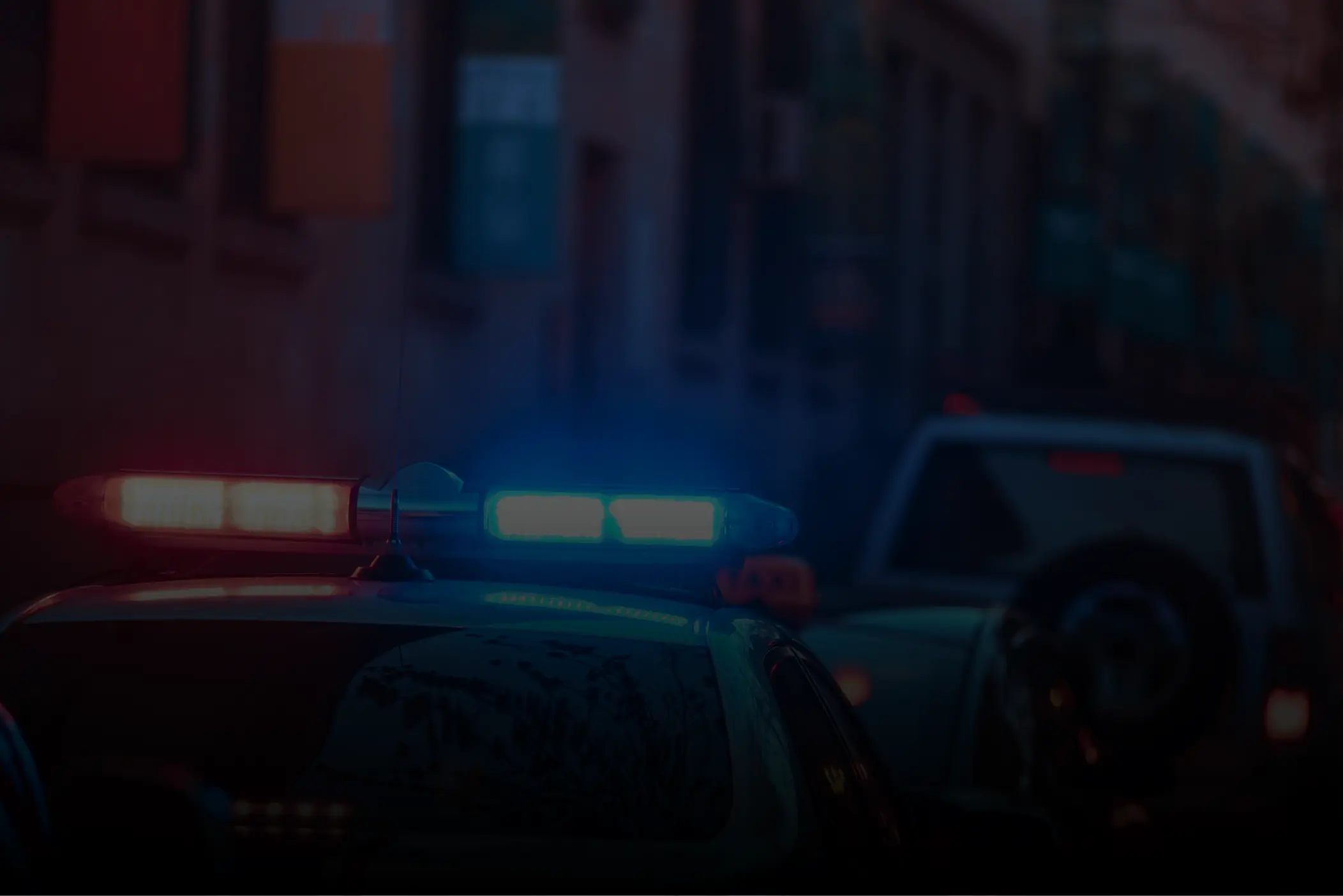 Blue light sector - police car Police car with red and blue flashing lights on a dark street at night.