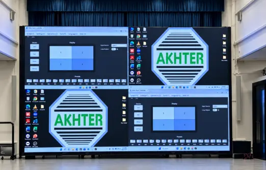Viasat security solutions Large indoor LED video wall displaying the Akhter logo and video wall control software screens in a modern auditorium setting.