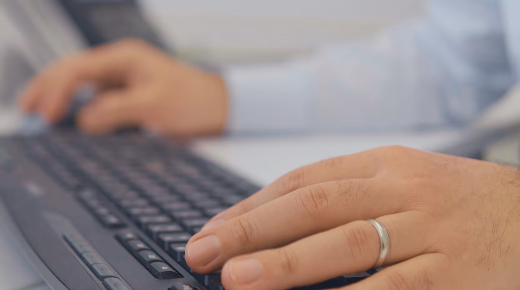 Close-up of hands typing on a keyboard