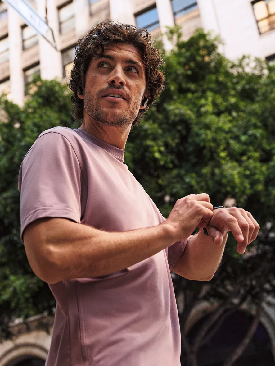 man in pink looking away