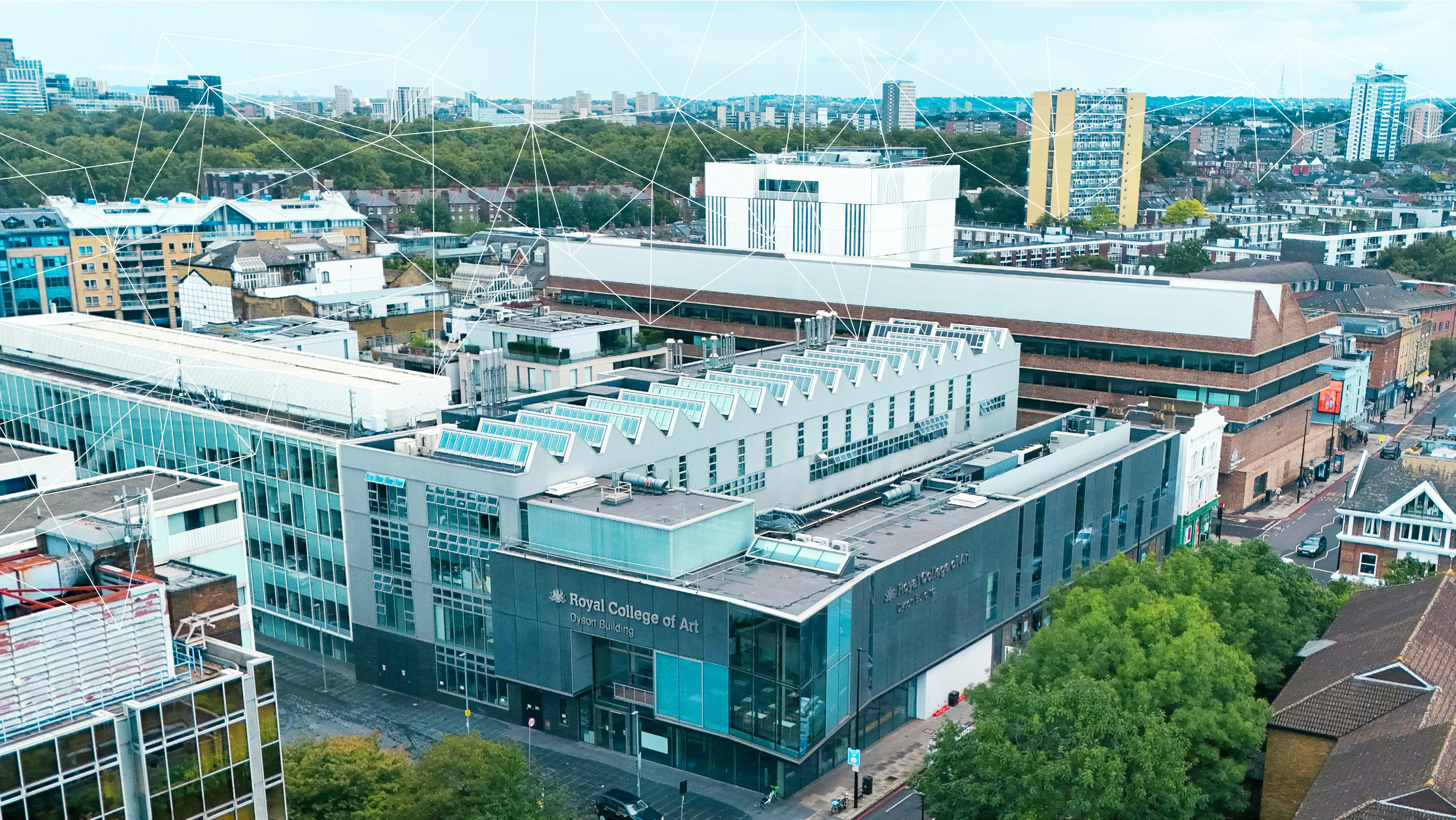 Aerial view of the Royal College of Art Dyson Building surrounded by city buildings and greenery.
