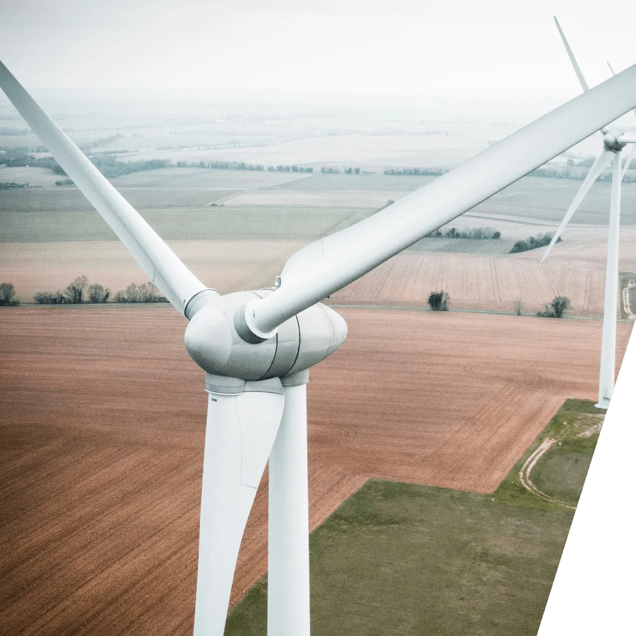 an aerial view of a wind farm and a wind turbine