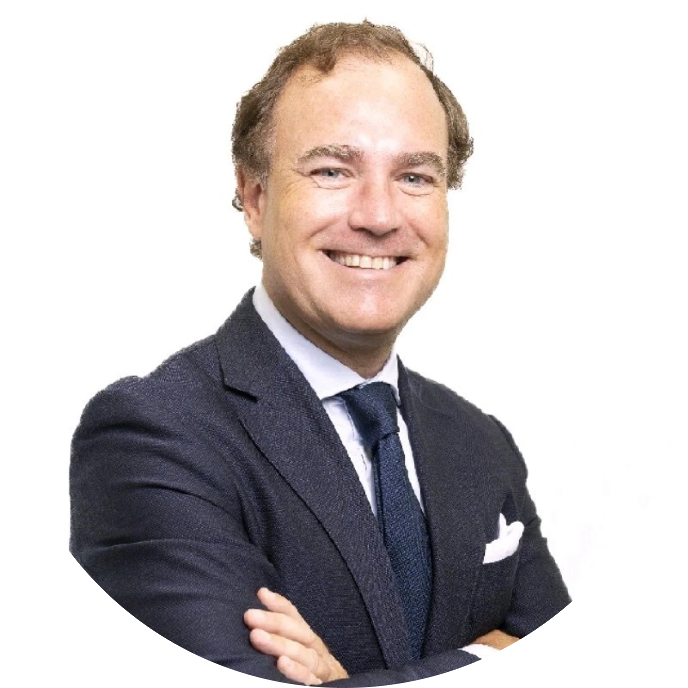 Smiling man in dark suit and tie with arms crossed against a white background.