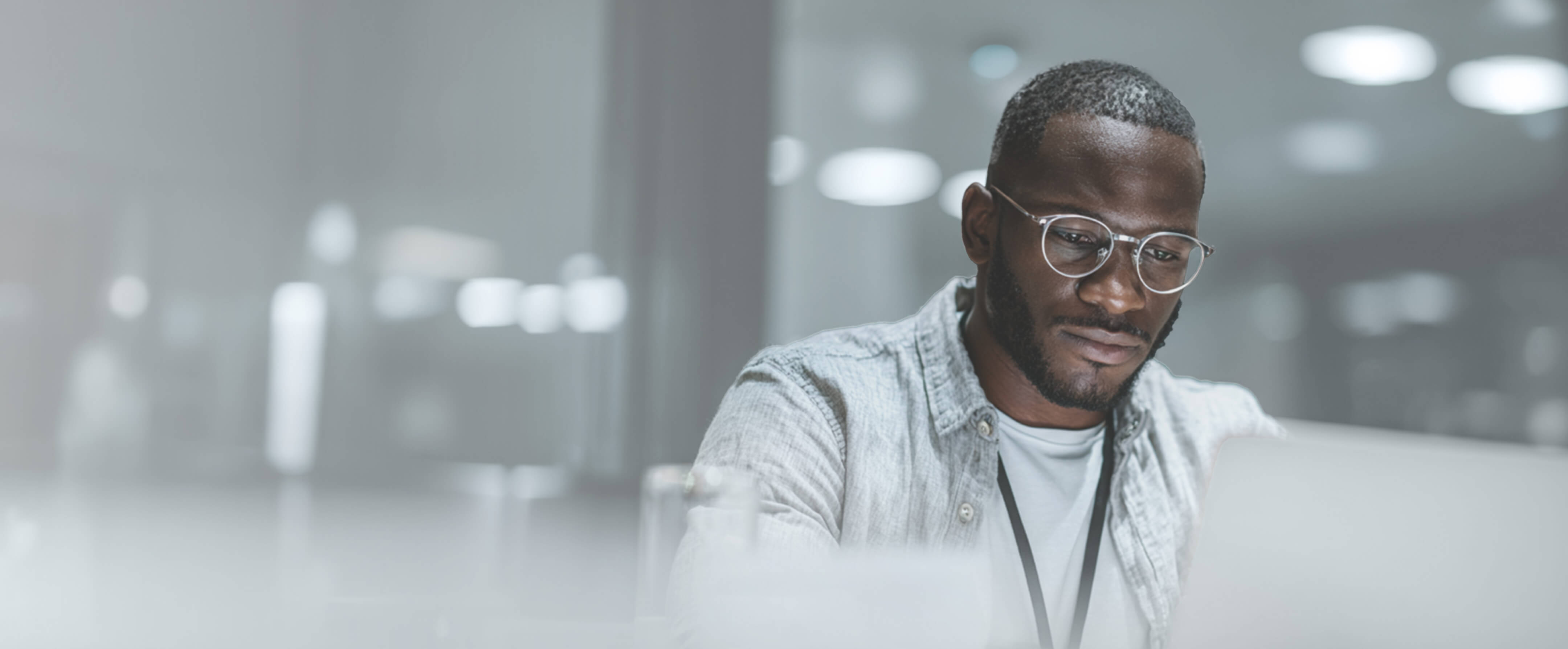 IT professional in an office setting working on a laptop for managed cybersecurity and threat response.