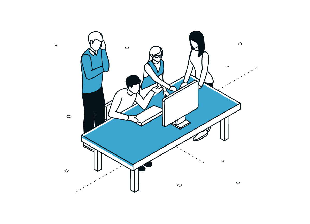 Four people collaborating around a desk with a computer monitor.