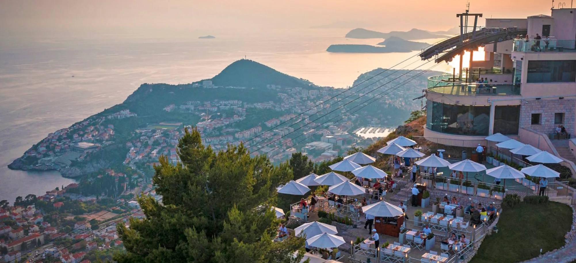 Sunset over the Dubrovnik coastline and Adriatic islands seen from the Panorama Restaurant terrace on Mount Srđ.