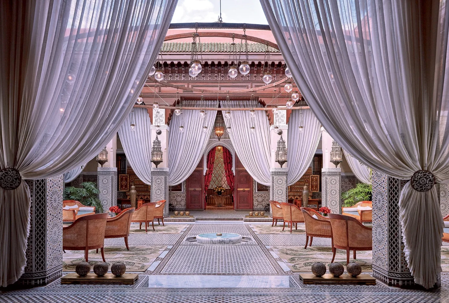 Draped courtyard at the Royal Mansour Marrakech with tiled floors, lanterns, and a central fountain.