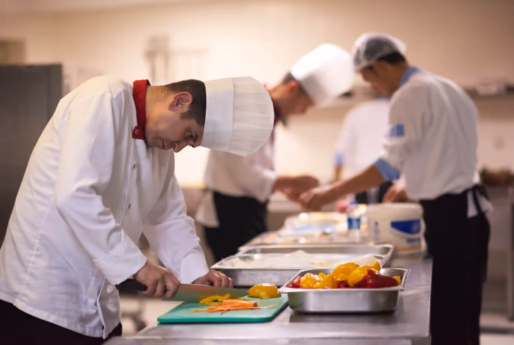 Food service worker preparing food in restaurant kitchen