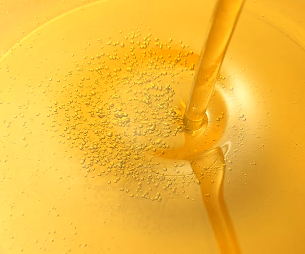Oil being poured into fresh oil