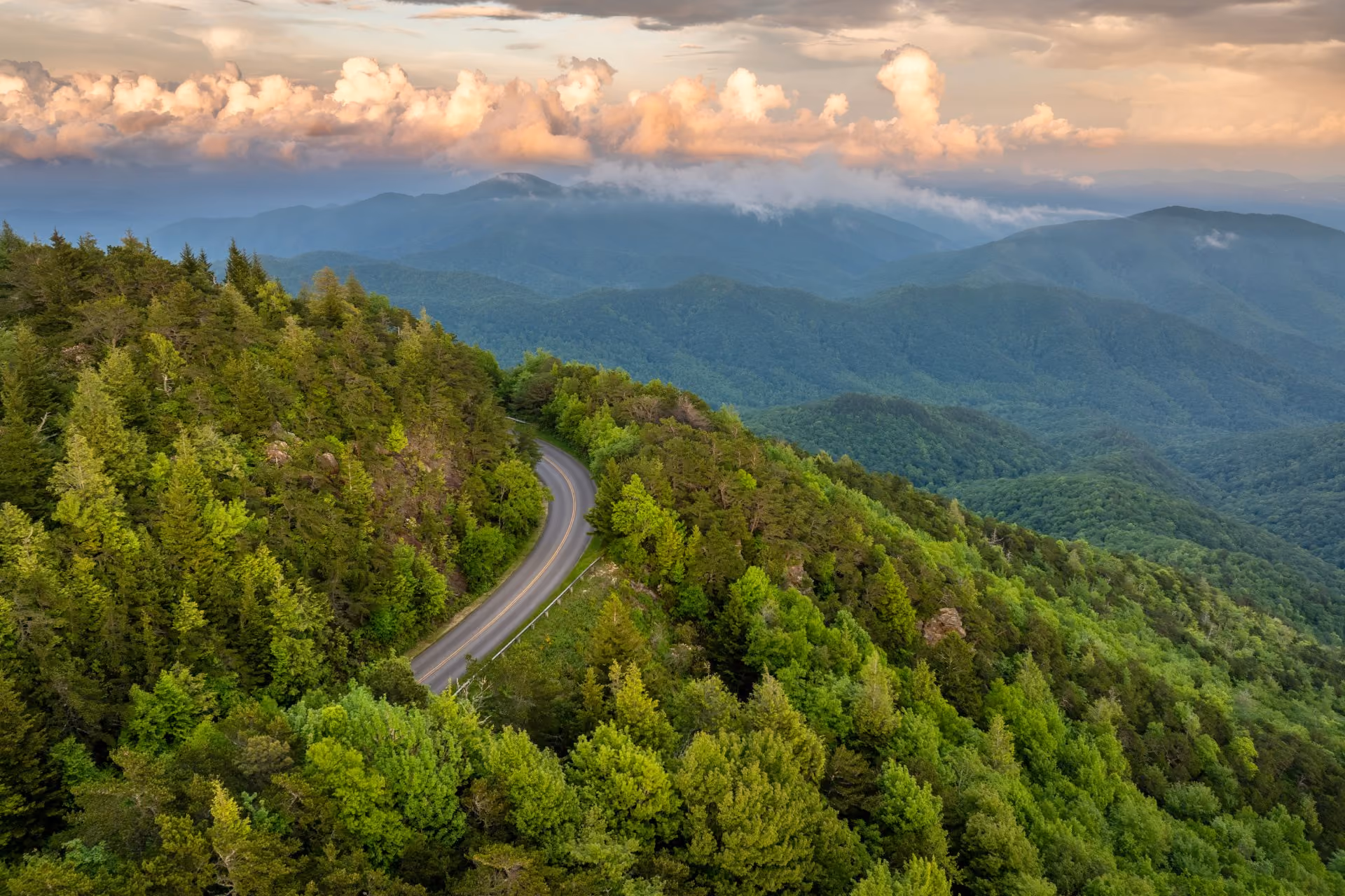Road cutting through hilly forest