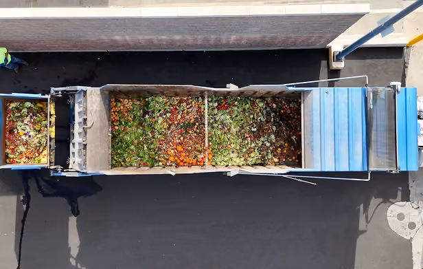 Overhead view of dump truck with organic material in it