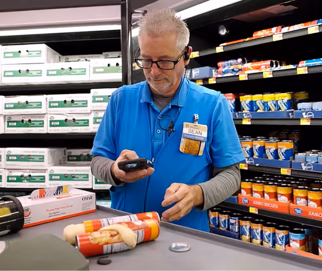 Walmart employee scanning broken food products for depackaging