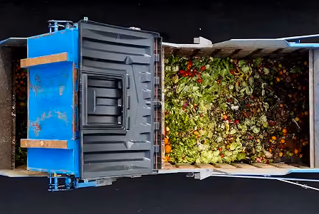 Truck picking up unused food