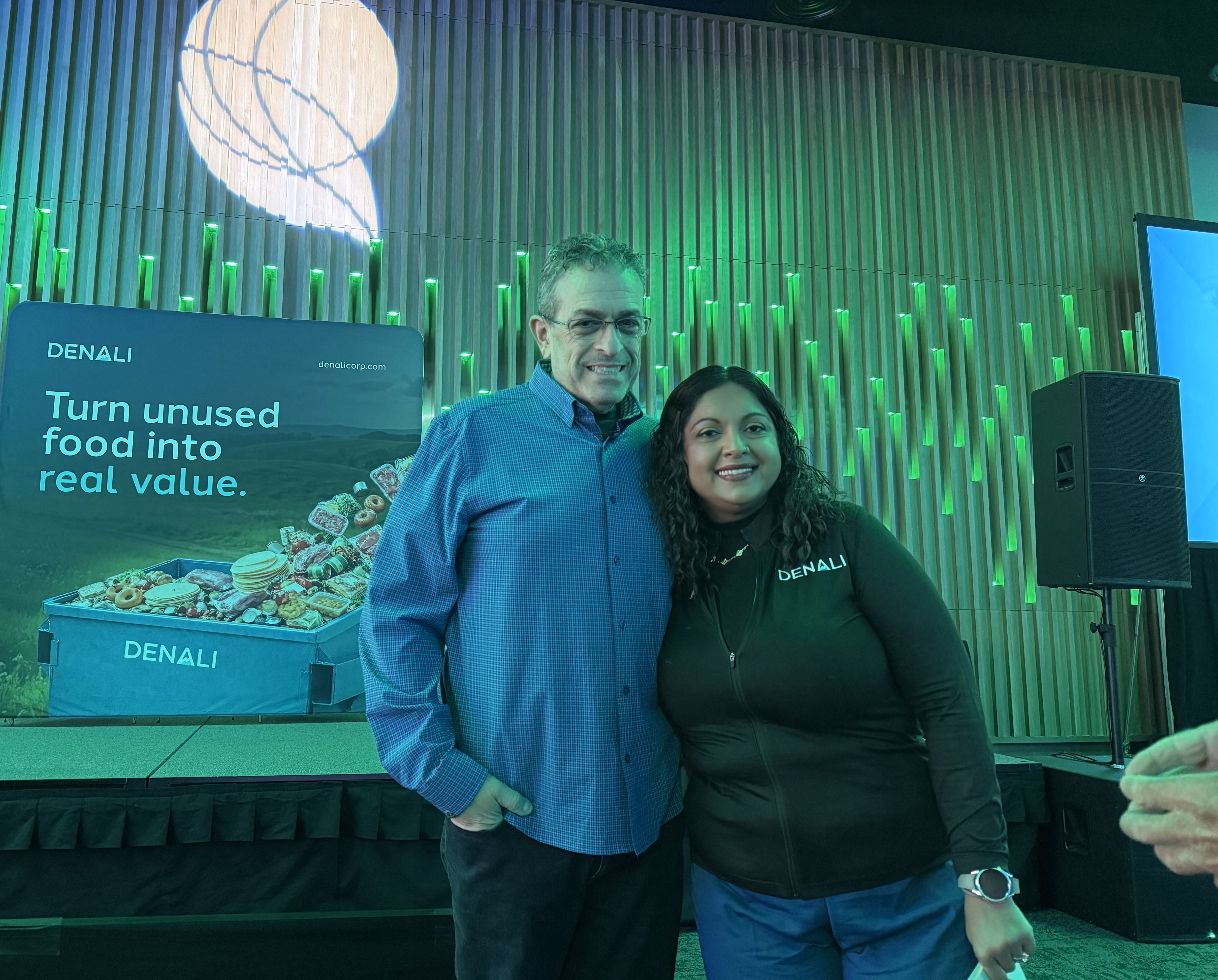 Two Denali team members posing together at the Green Sports Alliance Summit.