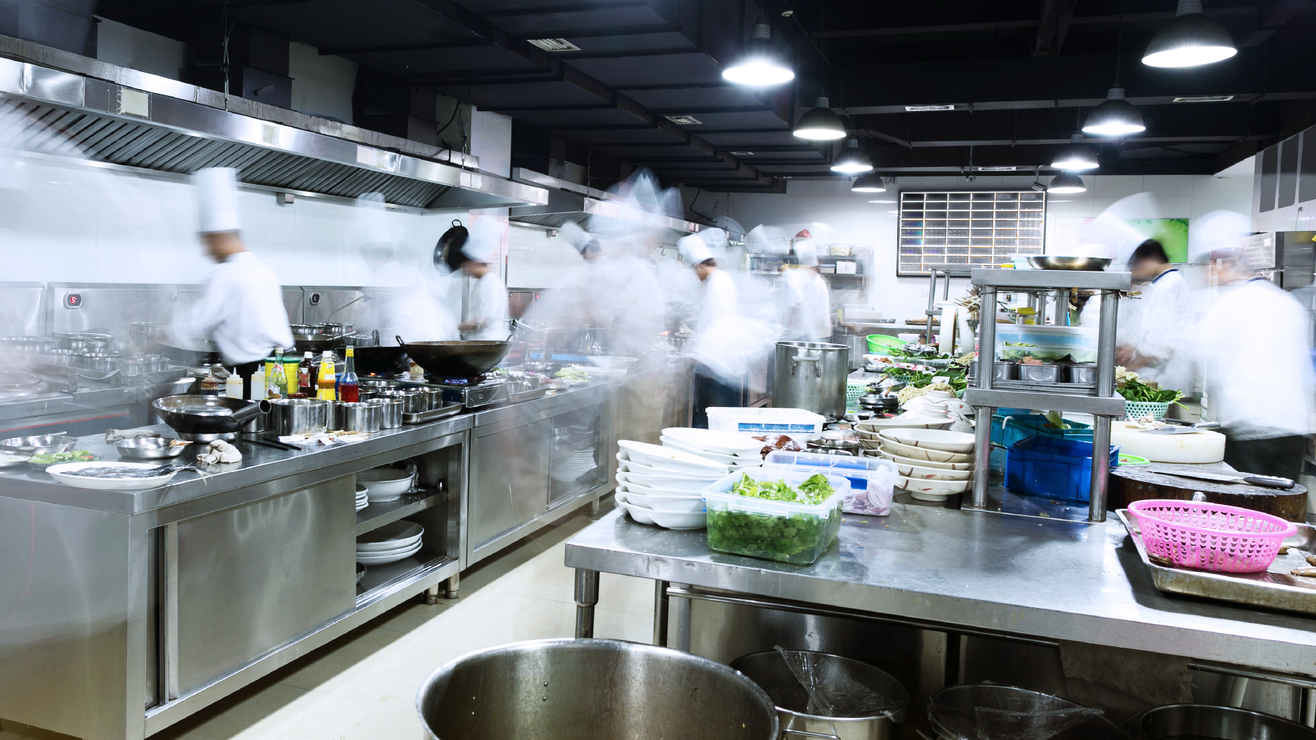 Busy kitchen with many people working on food prep