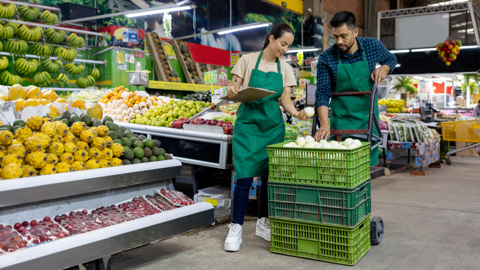 Grocery store workers sorting shipment of fresh onions