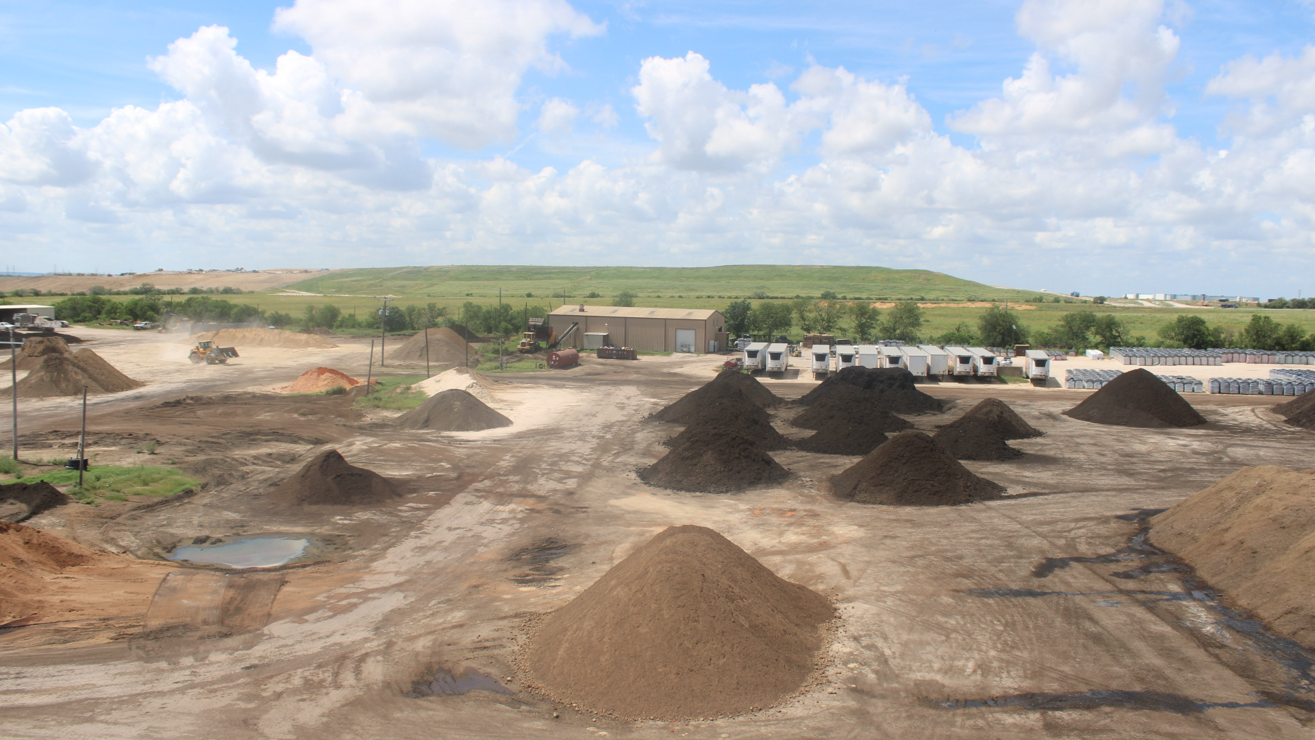 Aerial view of piles of dirt at soil production facility